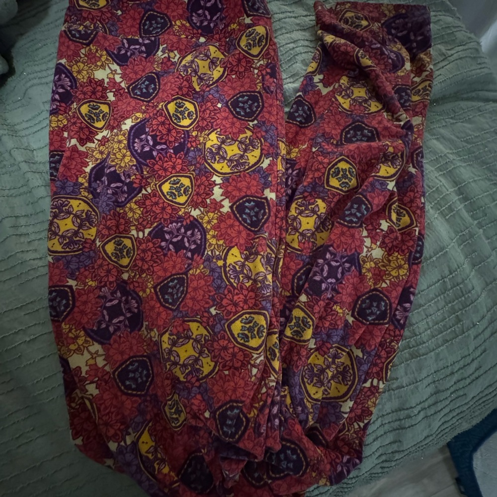 LuLaRoe OS One Size leggings in a pink, purple, yellow, and multicolor print